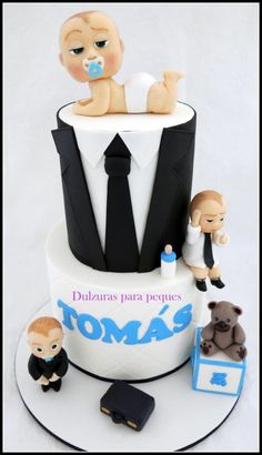 there is a cake that looks like a baby in a tuxedo on top