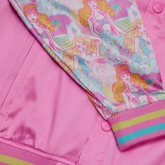 a pink and yellow jacket with barbie dolls on it