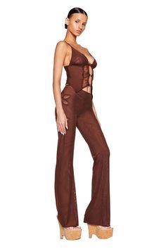 A woman is standing and posing in a brown, sheer I.AM.GIA two-piece outfit featuring a sleeveless top with lace-up details and the KELLER PANT - BROWN with flared legs and cut-out designs. She is wearing platform sandals and has her hair pulled back against a plain white background. Flower Cutout, Mesh Pants, Stretch Mesh Fabric, Low Rise Pants, Corset Style Tops, I Am Gia, Festival Dress, Buy Now Pay Later, Corset Style