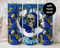 two cans with blue flowers and skulls on them