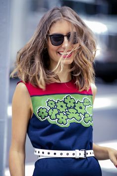 a woman with sunglasses on walking down the street