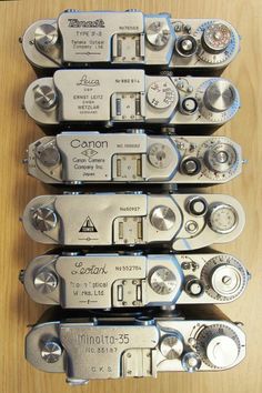 four different types of multimeters sitting on top of a wooden table