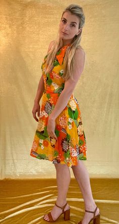 A Bright orange/yellow/green 60s printed chiffon sleeveless dress. The ideal festival/wedding halter neck dress. It's Shown on a Medium sized model. Chest measures 35 inches and total length is 36 inches. In good vintage condition. Mod Summer Beach Dresses, Summer Mod Beach Dresses, Orange Retro Print Summer Dress, Retro Halter Neck Summer Dress, Retro Sleeveless Halter Dress For Summer, Retro Orange Summer Dress, Orange Mod Dress With Retro Print, Mod Orange Dress With Retro Print, Retro Orange Dress For Beach