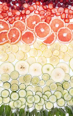 an image of fruits and vegetables arranged in the shape of a rainbow