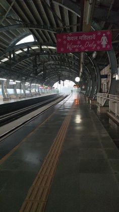 an empty train station with the lights on