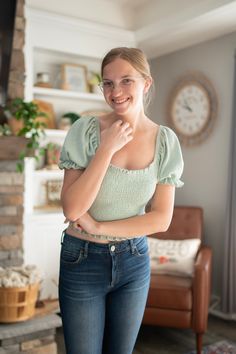 Make your mark with this Smocked & Smitten Over You Top! The sage-hued cotton gives you a winning combination of comfort and style, while the bubble cap sleeves add a touch of fun. Get ready to fall head over heels for this top - it's true-to-size and sure to turn heads! Green Puff Sleeve Smocked Top, Trendy Green Smocked Top, Casual Green Smocked Top With Puff Sleeves, Trendy Cotton Smocked Back Top, Trendy Cotton Smocked Top With Smocked Back, Trendy Stretch Smocked Top With Short Sleeves, Green Smocked Top With Short Sleeves For Summer, Green Smocked Top With Short Sleeves, Stretch Smocked Top With Short Sleeves