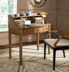 a desk with a chair and a clock on the wall above it in a living room