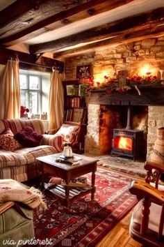 a living room filled with furniture and a fire place in the middle of it's fireplace