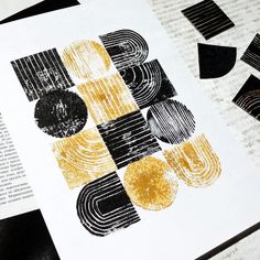 an open book with black and yellow designs on it