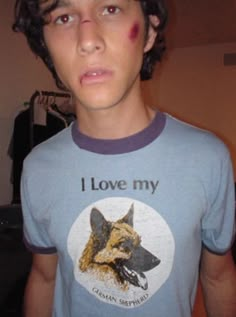 a young man wearing a t - shirt with the words i love my german shepherd on it