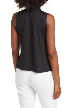 This super chic mock-neck sleeveless blouse is the perfect top whether it's in the office or out on the town. 25" length (size L) Mock neck Sleeveless Slips on over the head 95% polyester, 5% spandex Machine wash cold, tumble dry low Model Stats: 5'10" height; 34" bust; 27" waist; 35" hips. Model is wearing size L. Elegant Sleeveless Mock Neck Top For Spring, Chic Sleeveless Mock Neck Top For Summer, Spring High Neck Tank Top For Work, Spring Workwear High Neck Tank Top, Casual Sleeveless Mock Neck Top For Work, Chic Sleeveless Mock Neck Top For Work, Versatile Sleeveless Mock Neck Top For Spring, High Neck Summer Workwear Tops, Casual Sleeveless Mock Neck Top