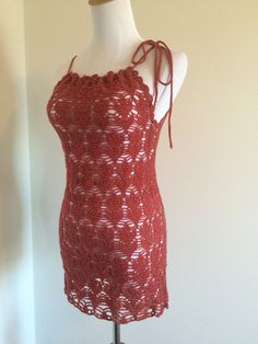 a red crocheted top on a mannequin