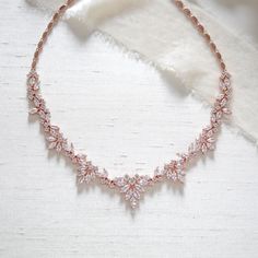 Our lovely rose gold bridal necklace is the perfect accent to your wedding gown with it's romantic vintage inspired design.   - Crafted with Premium Cubic Zirconia stones - Necklace measures 17 inches. - Available in rose gold, yellow gold and rhodium finish - Nickel free and hypoallergenic - READY TO SHIP ** if you would like to add a backdrop click here: https://www.etsy.com/listing/601882345/bridal-backdrop-back-drop-addition-add-a?ref=shop_home_active_20&crt=1 This is an original design by © Elegant Gold Bridal Necklace For Bridesmaids, Rose Gold Cubic Zirconia Bridal Necklace For Anniversary, Delicate Rose Gold Cubic Zirconia Necklace, Rose Gold Elegant Necklace For Anniversary, Delicate Elegant Necklace For Weddings, Delicate Rose Gold Bridesmaid Jewelry, Rose Gold Necklace For Wedding, Formal Rose Gold Bridal Necklace With Elegant Design, Formal Bridal Necklace In Rose Gold With Elegant Design