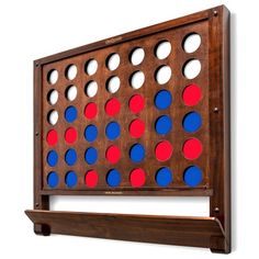 a wooden board game set with red, white and blue dots on it's sides