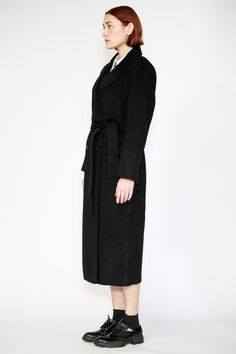 Indulge in timeless elegance with our Double-Sided Wool Black Wrap Coat. This heavyweight classic exudes sophistication and comes complete with a belt for versatile styling. The double-breasted design adds an extra layer of refinement, while the two pockets provide both style and convenience. Wrap yourself in luxurious fashion that effortlessly combines style and practicality. Composition: 100% Wool Heavyweight fabric Designed for a relaxed fit, fits true to size Coat length of a size M is 49.5 Black Wrap Coat, Luxurious Fashion, Winter Event, American Fashion Designers, Black Wrap, Wrap Coat, Asian American, Zambia, Office Wear