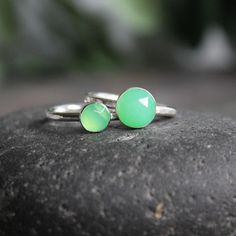 This stone is such a pretty shade of green! Chrysoprase is the gemstone for the broken hearted...who knew? This ring has a sturdy ring band with a 6mm or 8mm rose cut chrysoprase cabochon set in a sterling silver bezel. It can be worn with other stackable rings, or by itself. Handmade by Barb Macy in Corvallis, OR. Green Stackable Rings For May Birthstone, Adjustable Green Opal Ring, Green Sterling Silver Stackable Rings For May Birthstone, Handmade Green Stackable Rings For Gift, Green Sterling Silver Opal Ring For Promise, Handmade Green Stackable Rings For May Birthstone, Faceted Green Emerald Ring, Green Gemstone Stackable Rings For May Birthstone, Handmade Green Opal Promise Ring