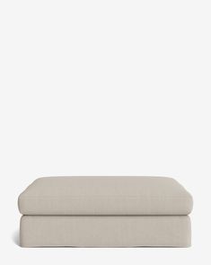 a white bench with two pillows on it and one foot resting against the backrest