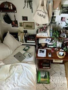 a bed room with a neatly made bed and lots of books