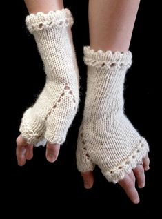 knitted fingerless gloves with laces and buttons on the fingers, in white