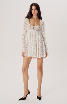 This baby-doll inspired dress is made from semi-sheer lace and makes for an elegant choice regardless of the occasion. The mini skirted bottom is pleated, so it’ll swish and sway beautifully. The square neckline is offset by subtly flared long sleeves. Semi Sheer Dress, Lace Patchwork Square Neck Dress, Square Neck Lace Dress With Lace Patchwork, Square Neck Lace Patchwork Dress, Feminine Lace Dress With Square Neck For Party, Feminine Square Neck Lace Dress For Party, Feminine Lace Mini Dress With Square Neck, Feminine Lace Dress With Square Neck, Chic Lace Dress With Square Neck