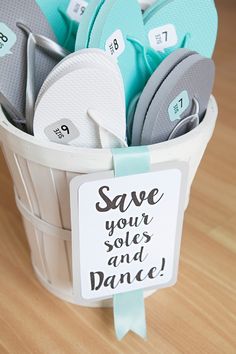 a basket filled with flip flops and a sign saying save your soles and dance