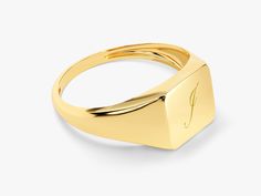 a gold signet ring on a white background