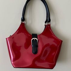 Beautiful Red/Black Hand Bag Never Used Buckle Is Actually A Magnetic Closure Top Zipper Closure Inside Has A Large Central Zipper Closure And A Smaller Zipper Pocket And One Small Slip Pocket Exterior Zippered Pocket On Back Of Bag Measures Approximately 10”L X6”H X4”D Dust Bag Included Trendy Red Shoulder Bag With Hasp Closure, Red Formal Bag With Hasp Closure, Red Tote Shoulder Bag With Snap Closure, Red Satchel Shoulder Bag With Snap Closure, Casual Red Evening Bag, Red Shopping Bag With Snap Closure, Red Bags With Snap Closure For Shopping, Everyday Red Shoulder Bag With Snap Closure, Red Shoulder Bag With Snap Closure For Everyday