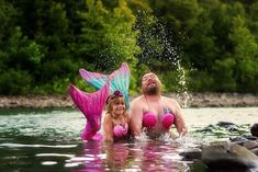 a man and woman in pink swimsuits are standing in the water next to each other