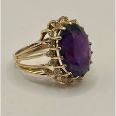 This is part of Chairish’s Fine Jewelry assortment.  14k yellow gold cocktail ring featuring a deep purple/red/blue oval amethyst, encircled by 16 small diamonds.  Ring Size: 6 in. Stone: 16.42 x 12.40 x 8.7 mm Ring Weight: 6.7 grams  If you would like more information, please contact me via email, mrboult@gmail.com. Yellow Gold Cocktail Ring, Green Pendant, Amethyst And Diamond Ring, Green Pendants, Gold Cocktail Ring, Gold Cocktail, Diamonds Ring, Diamond Cocktail Rings, Jewelry Business