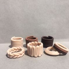 several different types of rubber rings and bracelets on a gray surface with white background