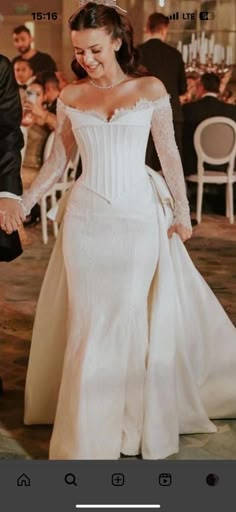 the bride and groom hold hands as they walk down the aisle