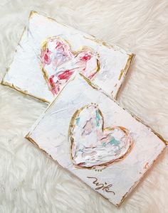 two heart shaped paintings on white fur