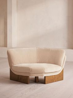 a white couch sitting on top of a hard wood floor