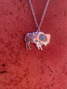 ♠️ intricate engraved details ♠️ includes a 2 inch extender for additional length ♠️ great stacker ✨savannah, one of our boer doelings, modeling the first Bison Pendant ever made😇 pendant measurements length: 1 1/4in height: 2 1/4cm turquoise stone measurement: 1/2cm Silver Hand-stamped Bohemian Jewelry, Silver Bohemian Hand Stamped Jewelry, Bohemian Silver Hand Stamped Jewelry, Hand Stamped Silver Bohemian Jewelry, Personalized Blue Bohemian Jewelry, Stamped Turquoise Round Jewelry, Turquoise Stamped Round Jewelry, Stamped Round Turquoise Jewelry, Southwestern Jewelry With Adjustable Chain