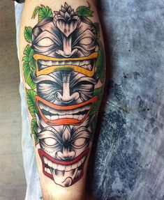 a man's leg with a tattoo on it and an image of a mask