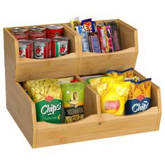 two wooden containers filled with food and snacks on top of each other, one containing chips