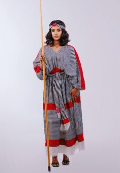 Step into the colorful world of Wellega with this stunning handwoven Suf dress. The vibrant and eye-catching patterns of this traditional dress reflect the rich heritage and history of the Wellega people. Expertly crafted with care and attention to detail, this dress is made from high-quality, handwoven Suf fabric, ensuring that it is both comfortable and durable. The elegant and flattering cut of the dress complements any figure, making it perfect for any occasion. Whether you're attend an even Oromo Cultural Dress, Oromo People, History Of Ethiopia, Eritrean Dress, Ethiopian Culture, Cultural Dress, Ethiopian Clothing, Traditional African Clothing, Colorful World