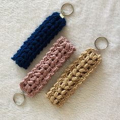 two crocheted key chains are laying next to each other