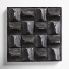 an abstract wall sculpture made out of wooden blocks