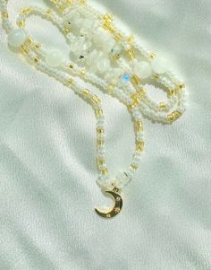 "Made to order gold and pearl white glass beads with moonstone crystals and a 14k gold filled moon charm! Removable and adjustable up to 2\" with a choice of silver or 14k gold clasp.  In the notes please include what length you would like your beads! Measure your waist wherever you want your beads to fall as shown in the listing photo. Moonstone 🌙 is good for enhancing your intuition, balancing emotions, and inspires new beginnings. Custom waist beads are available through message or DM on Instagram! Chakras: Sacral, Crown All crystals are charged under moonlight of the new moons and cleansed with palo santo before they are mailed." White Moon Phase Jewelry For Meditation, Healing White Moon Phase Jewelry, Spiritual Gold Beaded Bracelets With Moonstone, White Moonstone Crystal Necklace With Moon Charm, White Spiritual Crystal Necklace With Moon Charm, White Moon Shaped Spiritual Necklaces, Spiritual White Necklace With Moon Charm, White Moon Shaped Spiritual Necklace, Spiritual White Moon Necklaces