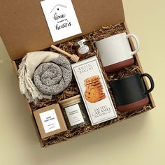 an open box containing coffee, cookies, and other items for the home sweetests