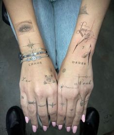 two hands with different tattoos on them and one has the word chaos written on it