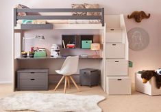 a child's bedroom with a loft bed, desk and storage bins for toys