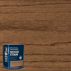 a can of wood stain sitting on top of a wooden floor