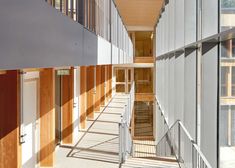 the inside of a large building with lots of windows on each side and stairs up to the second floor