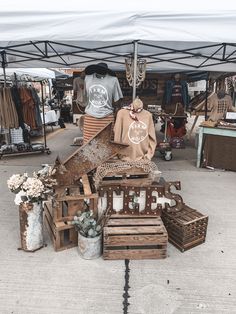 an outdoor market with wooden crates and other items