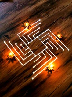 a wooden table topped with candles and an illuminated maze