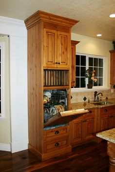 a kitchen with wooden cabinets and marble counter tops