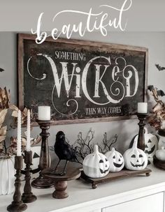 a mantle with candles, pumpkins and other decorations in front of a sign that says beautiful