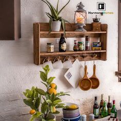 a wooden shelf filled with pots and pans next to a potted plant on top of a counter